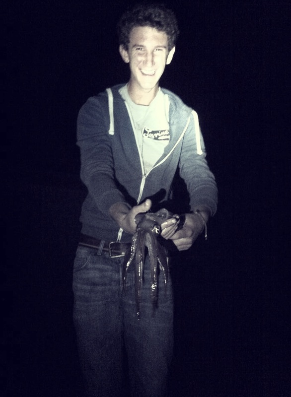 holding a squid in the night