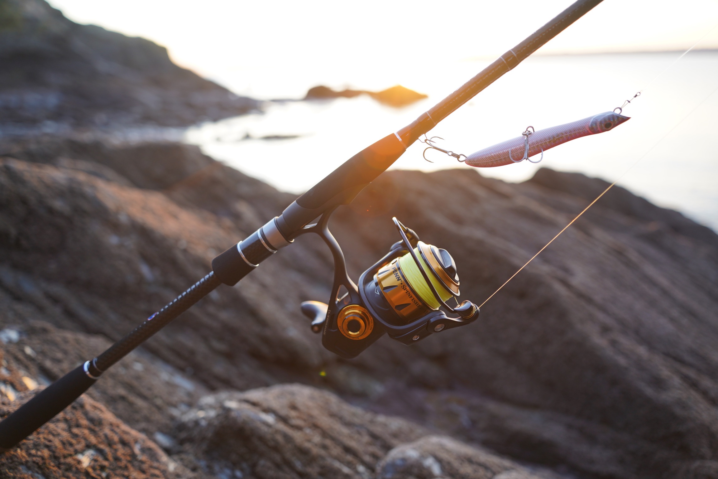 lure fishing rod and reel on the rocks