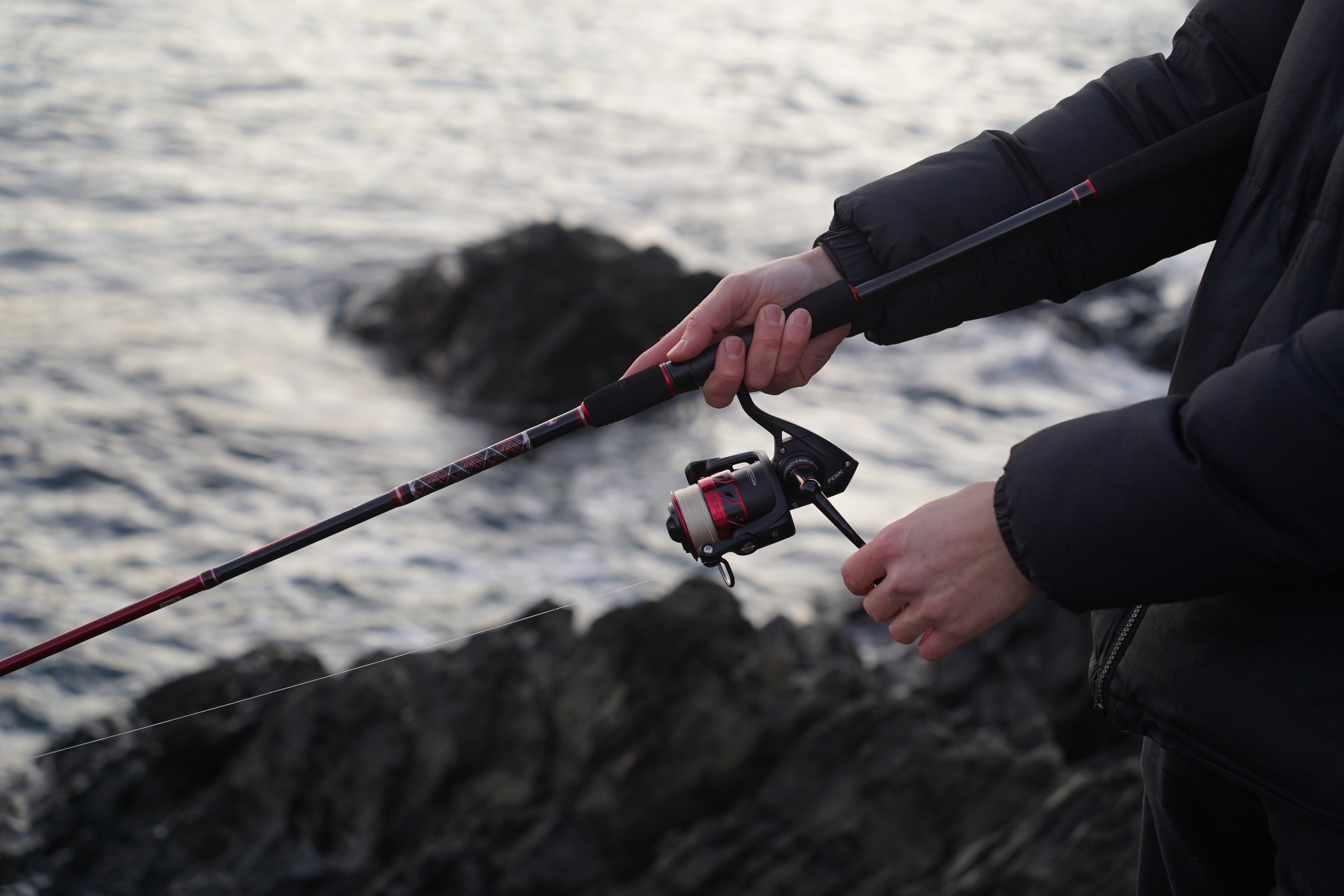 spinning rod and reel being used for mackerel fishing